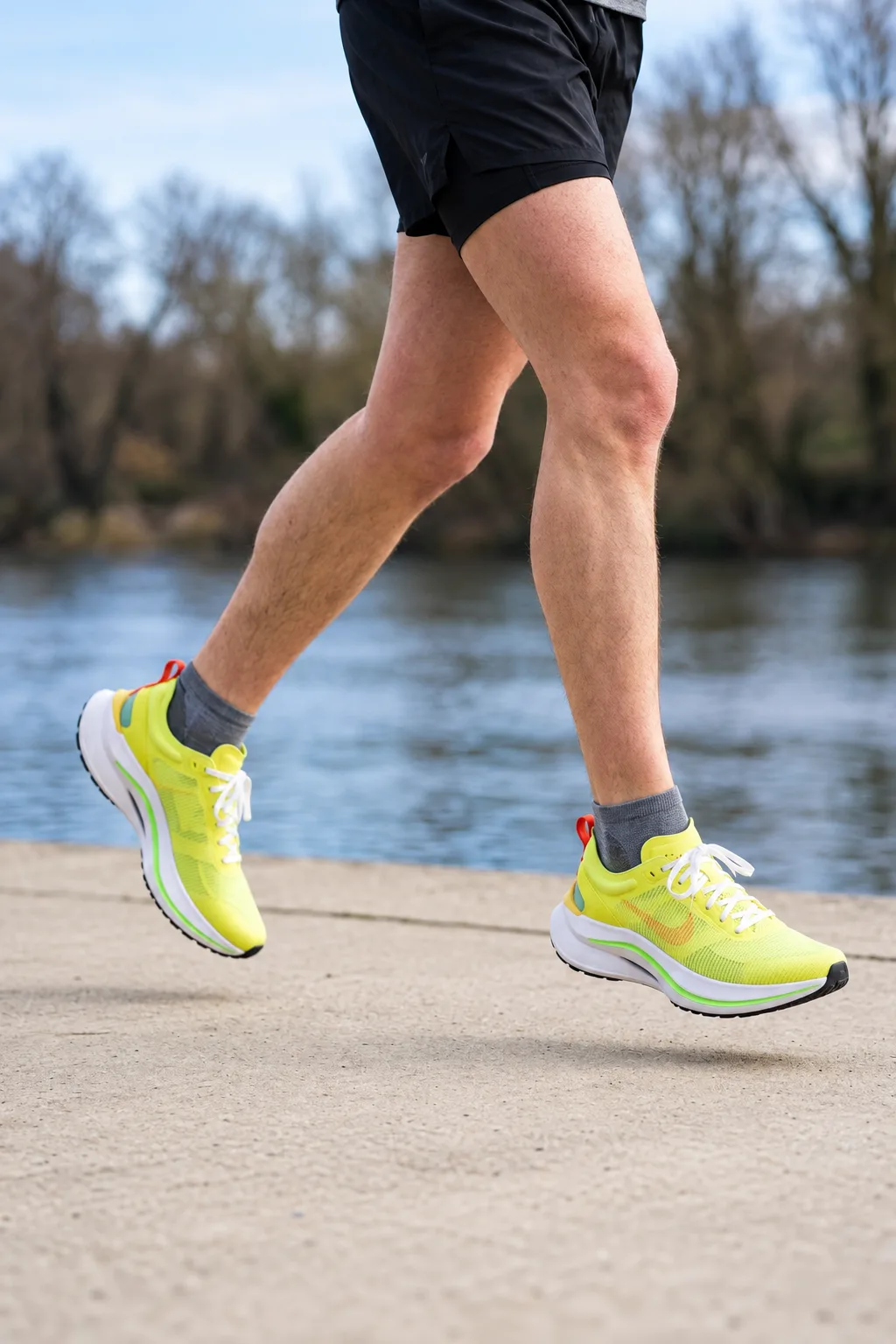 Tempo in Lime mid-stride on a riverside path